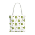 Tote bag with green book and martini glass pattern on a white background