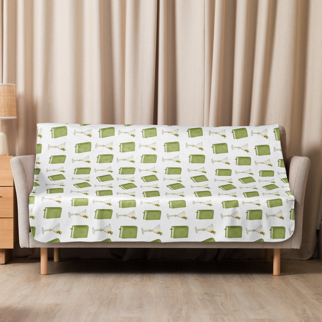 50x60" sherpa lined blanket with dirty martinis and green books on it , product mock-up image laying over couch
