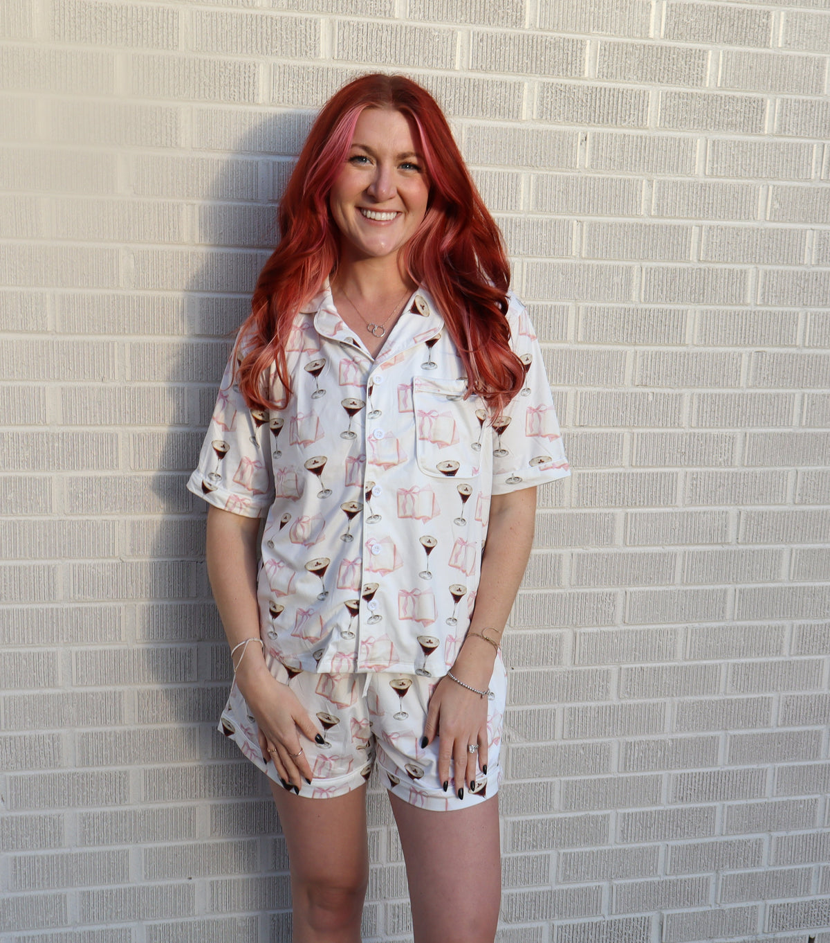 woman in front of wall wearing white pajamas