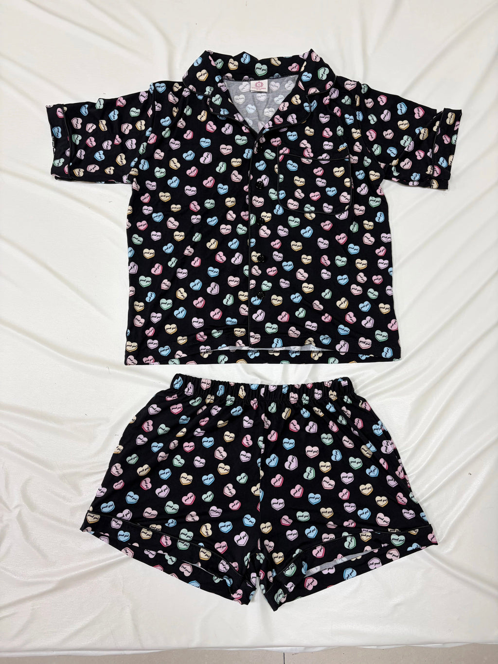 Black pajama set with colorful pattern on a white background