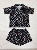 Black pajama set with colorful pattern on a white background