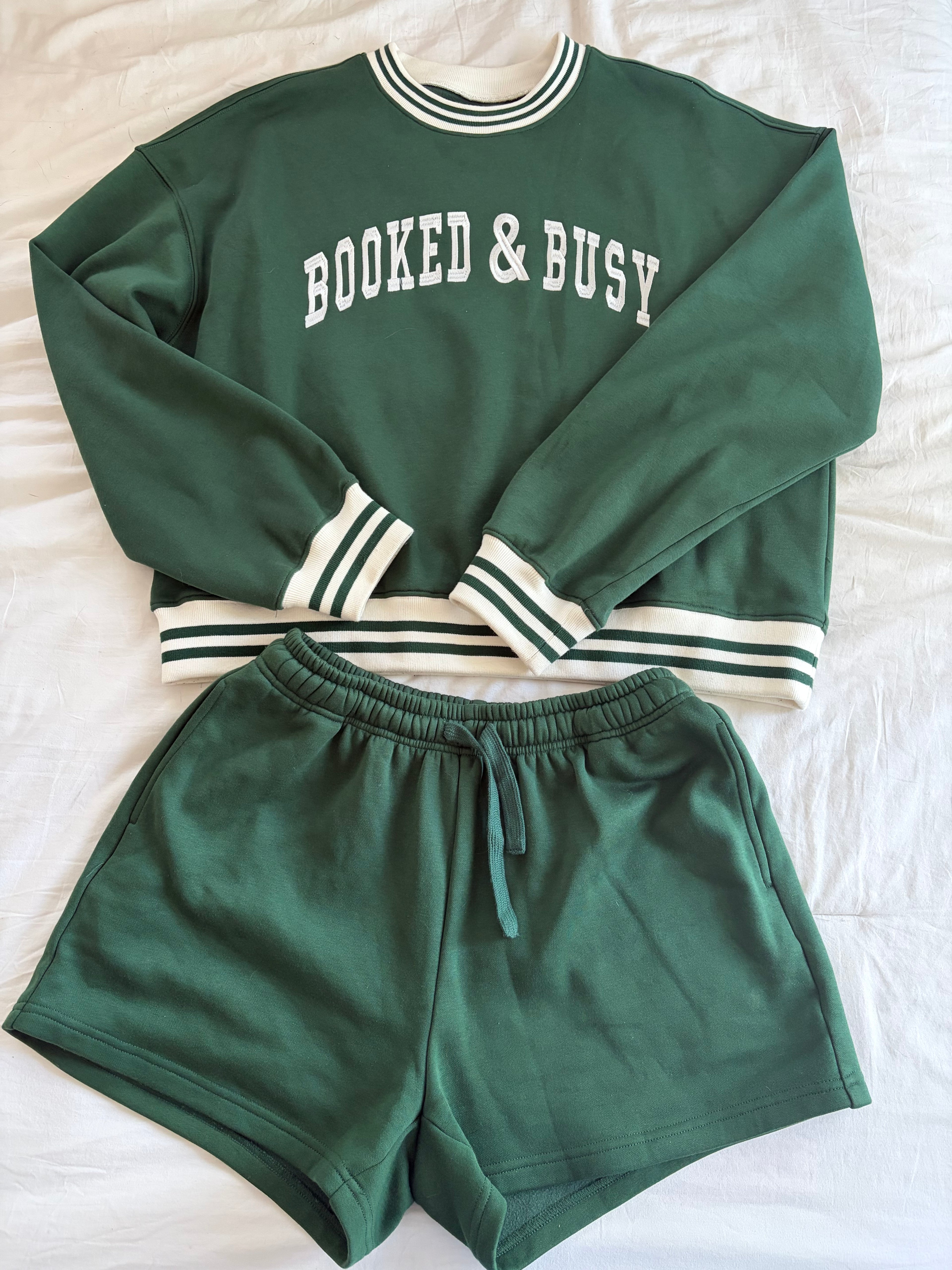 Green sweatshirt and shorts set with 'Booked & Busy' text on a white background