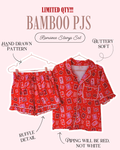 A promotional graphic for a red patterned pajama set labeled 'BAMBOO PJS' with text callouts including 'HAND DRAWN PATTERN', 'BUTTERY SOFT', 'RUFFLE DETAIL', and 'PIPING WILL BE RED, NOT WHITE'. The set includes a short-sleeve button-front top and matching shorts on hangers against a pale pink background.
