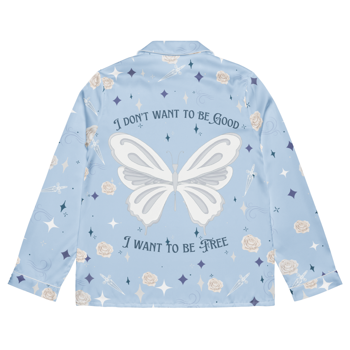 A light blue long-sleeve pajama shirt shown from the back, featuring a large white butterfly graphic in the center, the text 'I DON'T WANT TO BE GOOD' above and 'I WANT TO BE FREE' below, with scattered white, beige, and navy floral and star motifs.
