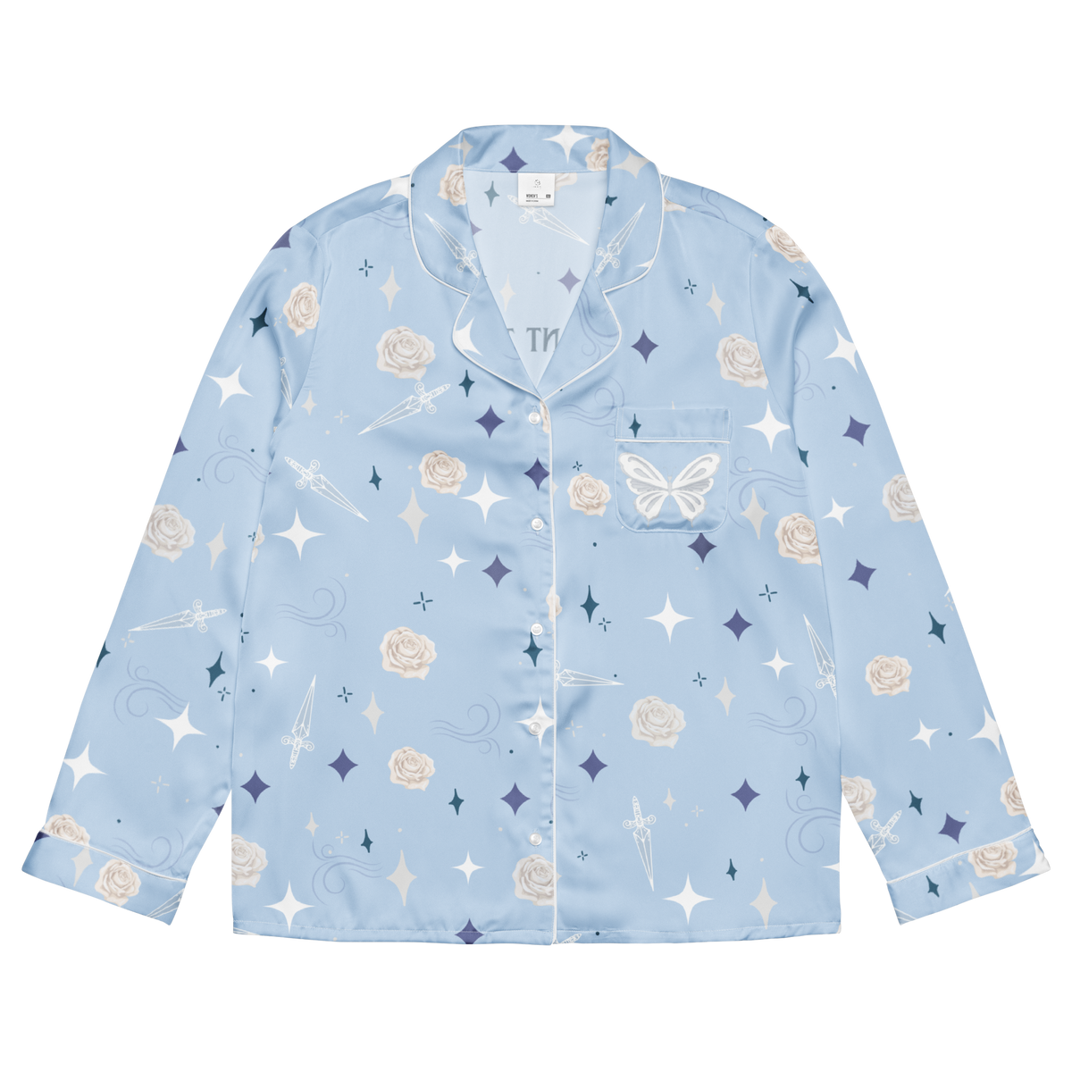 A light blue long-sleeve pajama shirt with a white, navy, and beige celestial print featuring stars, moons, roses, and a butterfly, shown flat on a white background.