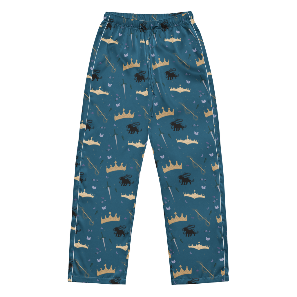 A pair of children's long pants in a teal blue color, featuring an all-over print of gold and beige crowns, black lions, and small blue birds, with white piping along the side seams.