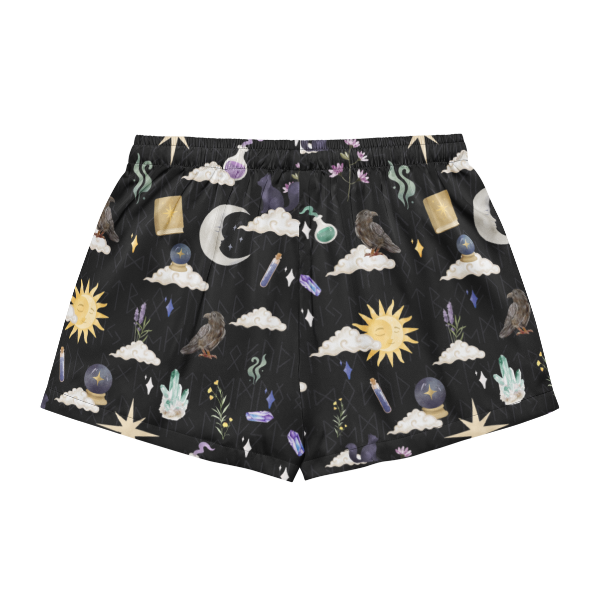 Black shorts with an all-over mystical and occult-themed print featuring crows, crescent moons, crystals, stars, and suns on a white background.