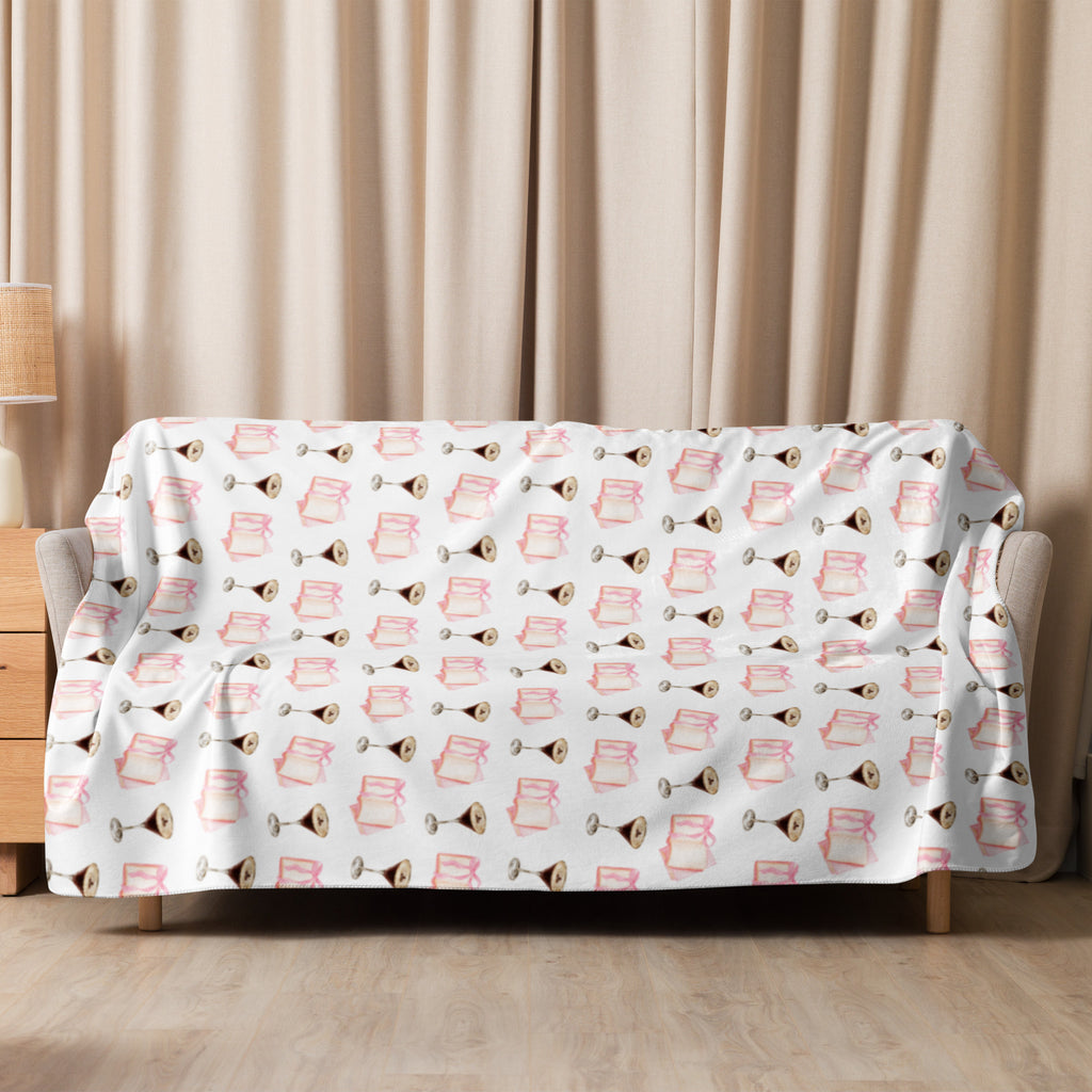 60 by 80  Sherpa lined blanket with espresso martinis and pink books product mock-up, laying over couch