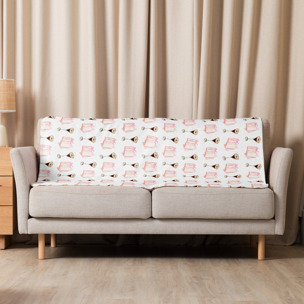 37x50  Sherpa lined blanket with espresso martinis and pink books product mock-up, laying over couch