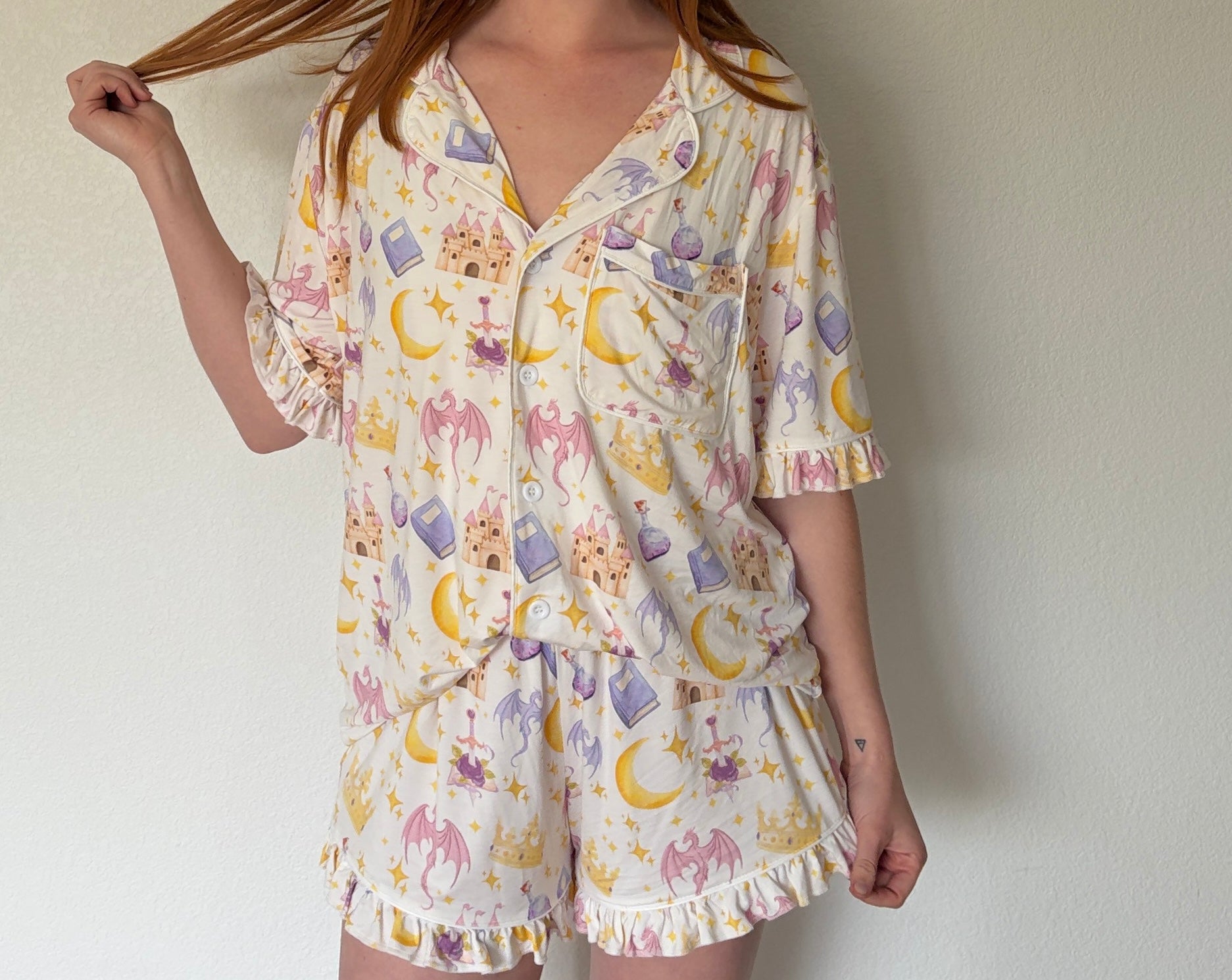 Person wearing a patterned pajama set against a plain background