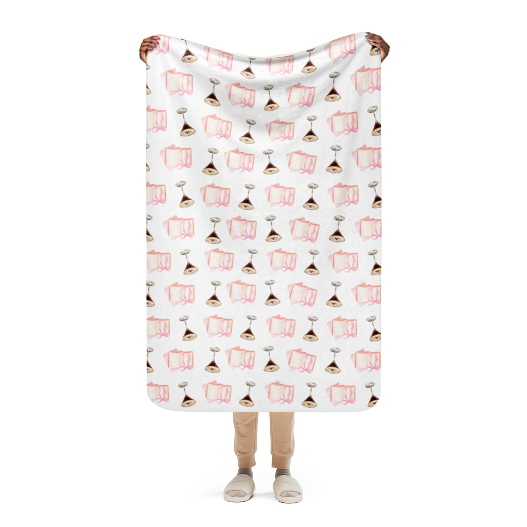 woman holding up 37x50 " Sherpa lined blanket with espresso martinis and pink books product mock-up image