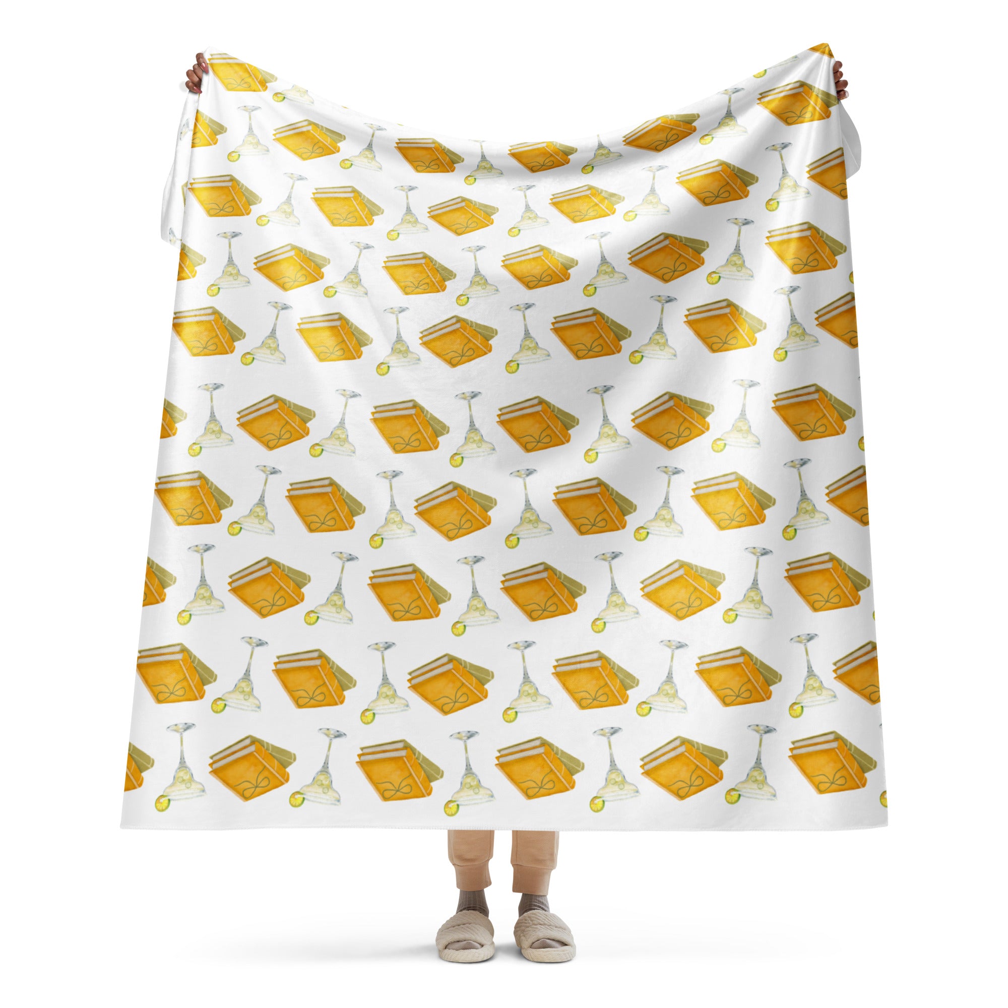 woman holding up 60 by 80"  sherpa lined blanket with spicy margaritas and books, product mock-up image