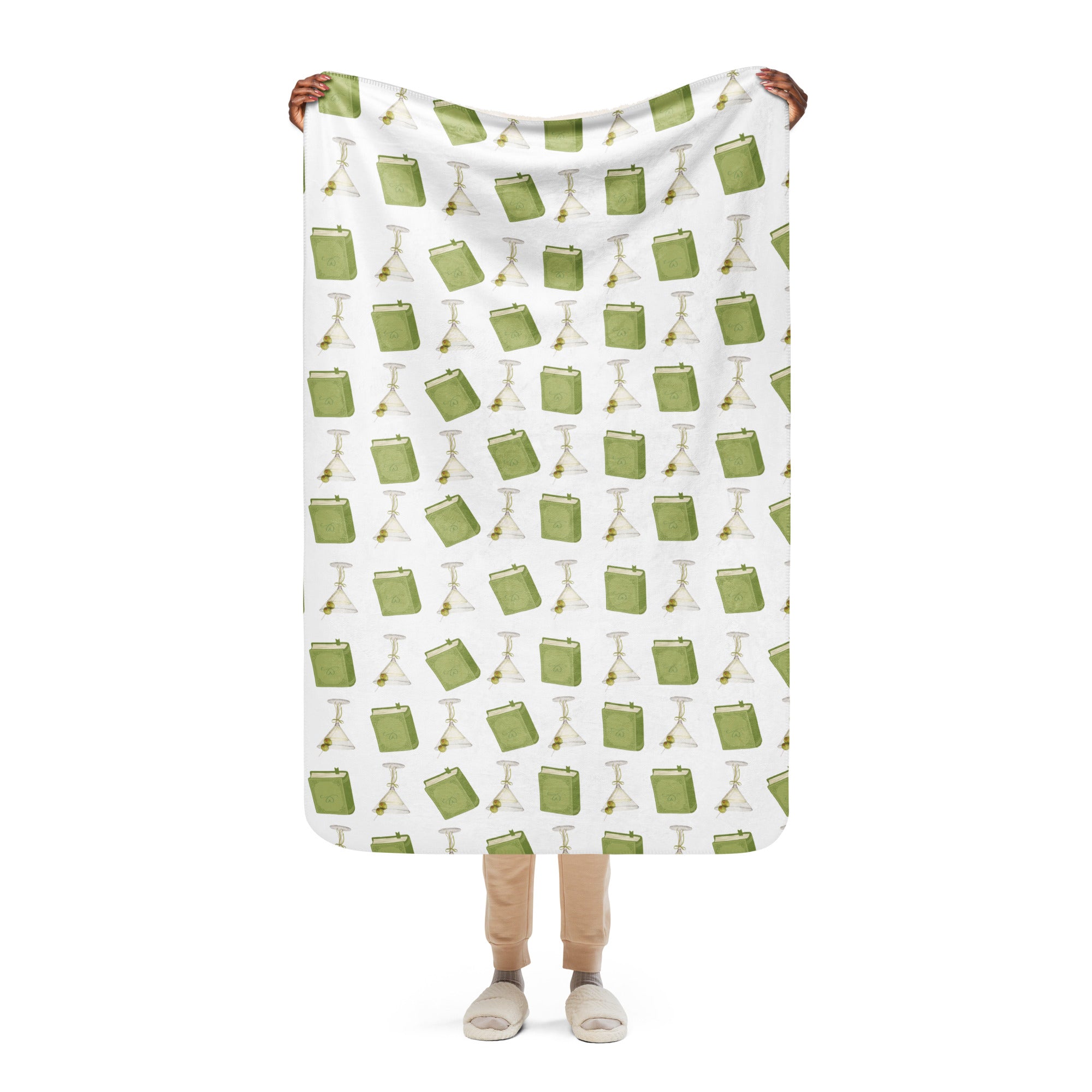 woman holding 37x50 " sherpa lined blanket with dirty martinis and green books on it , product mock-up image